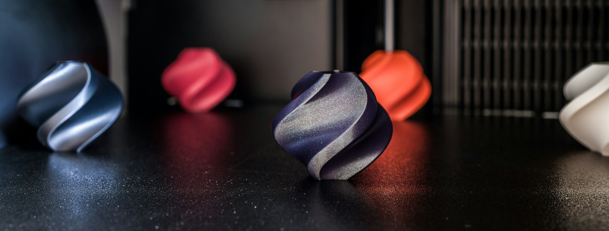 Colourful 3D printed parts in different filaments on a Bambu Lab build plate